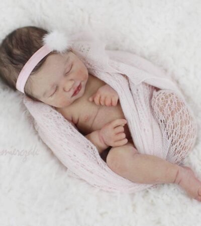 Baby Rosalee realistic reborn baby doll with dark rooted hair and closed eyes sleeping peacefully