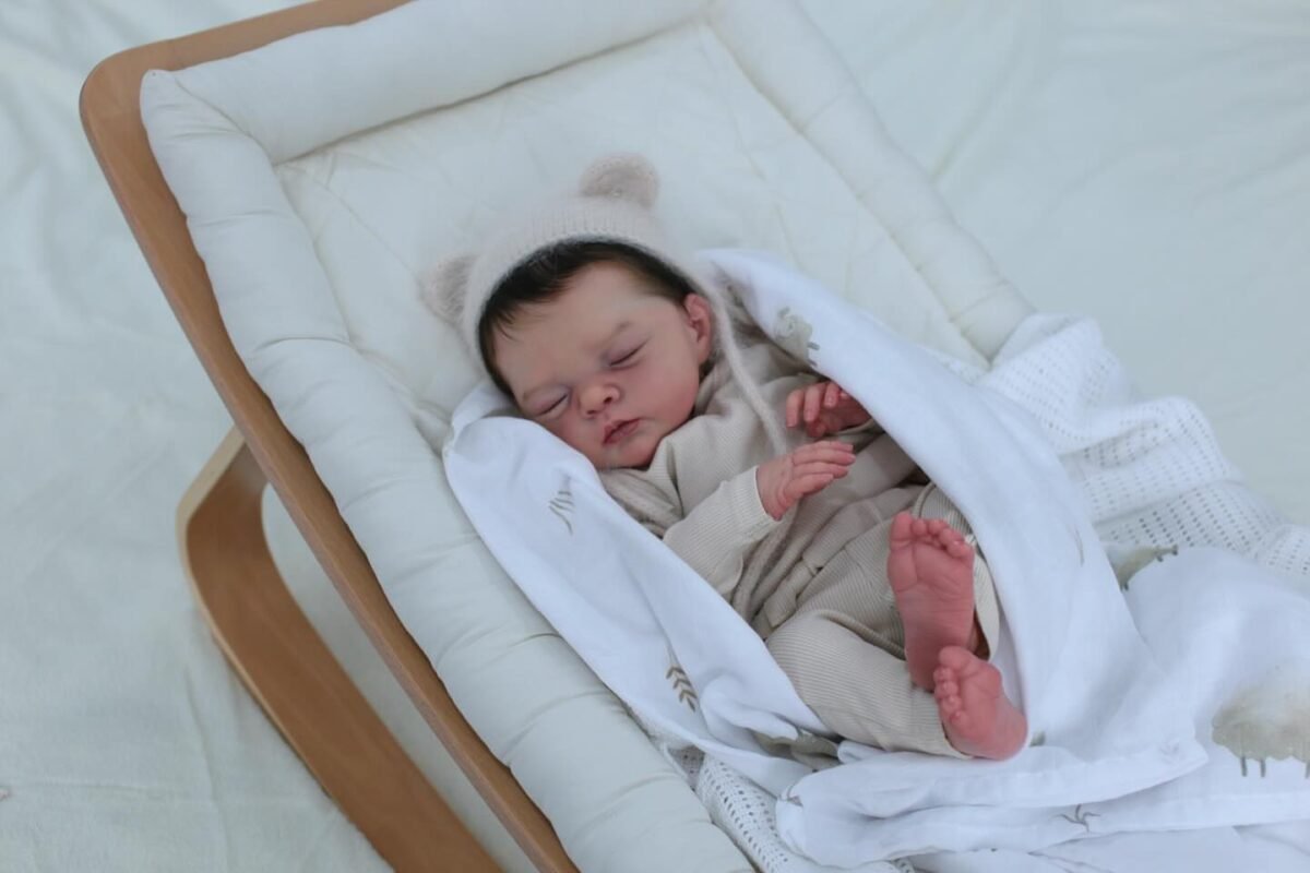 Baby Irys by Joannie Kazmierczak reborn doll with rooted black hair and Marshmallow blend paint