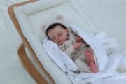 Baby Irys by Joannie Kazmierczak reborn doll with rooted black hair and Marshmallow blend paint